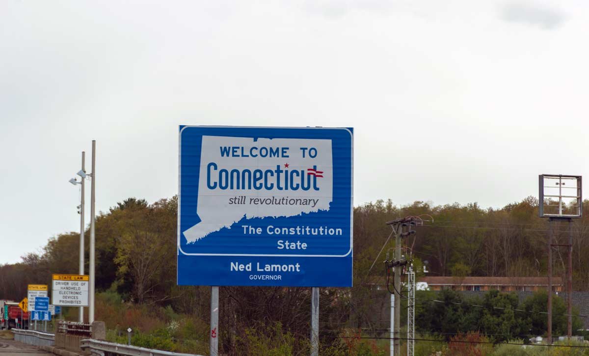 Welcome to Connecticut sign on a gray cloudy day