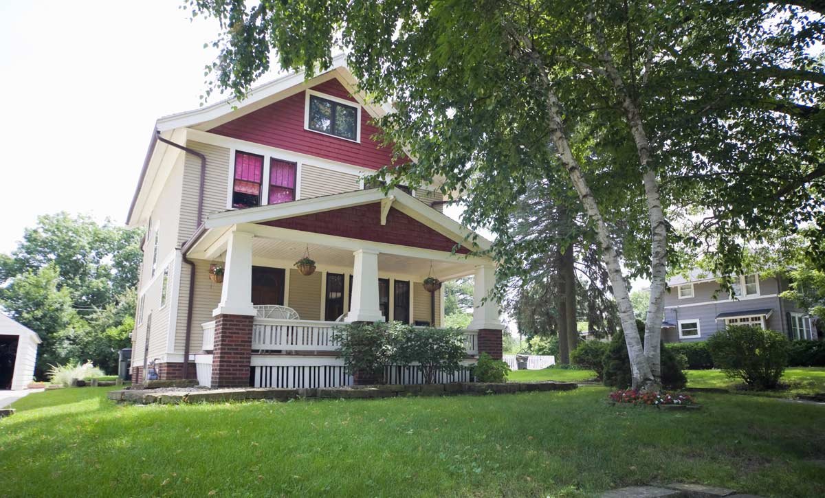 Iowa home with large porch and tree in the front yard