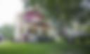 Iowa home with large porch and tree in the front yard